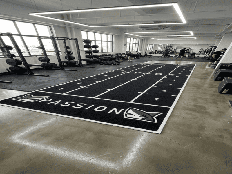 Close up of water draining through turf backing during a rain test